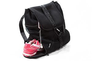 Backpack with a sneaker in shoe compartment and IPhone in the secure side zip pocket, which fits an IPhone Plus. 